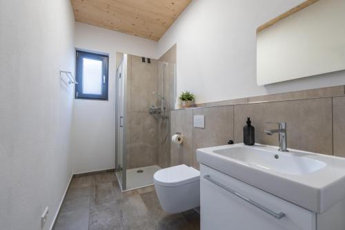 a bathroom with a sink and a toilet and a shower at Casa CaVi Bergheider See in Buschmühle
