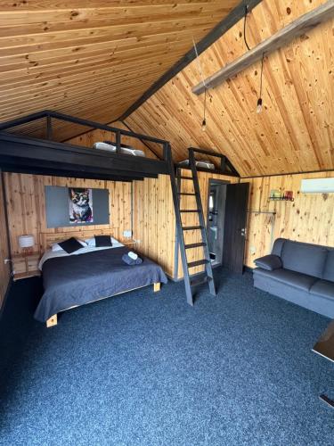 a bedroom with a bunk bed and a couch at СвояХата in Svityazʼ