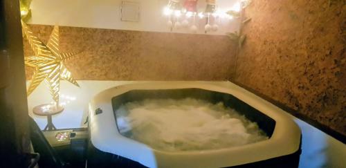 a bathroom with a bath tub filled with water at Rózsa apartman in Odorheiu Secuiesc