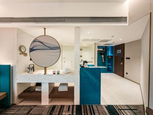 a bathroom with a sink and a mirror at Asia International Hotel Guangdong in Guangzhou