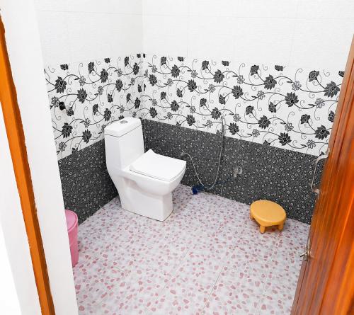 a small bathroom with a toilet in a room at Hotel Padam Niwas in Ukhimath