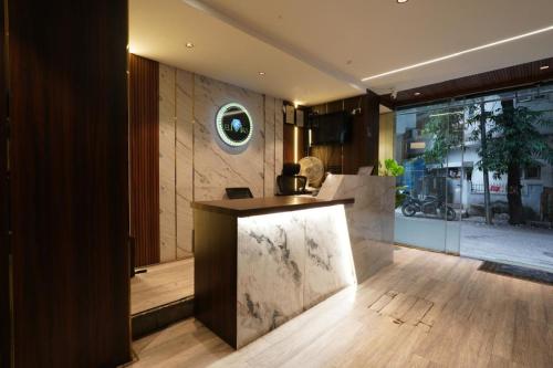 a kitchen with a counter in the middle of a room at Hotel Elmas in Bangalore