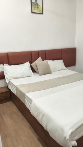 two beds sitting next to each other in a room at Mark inn hotel in Hanumāngarh