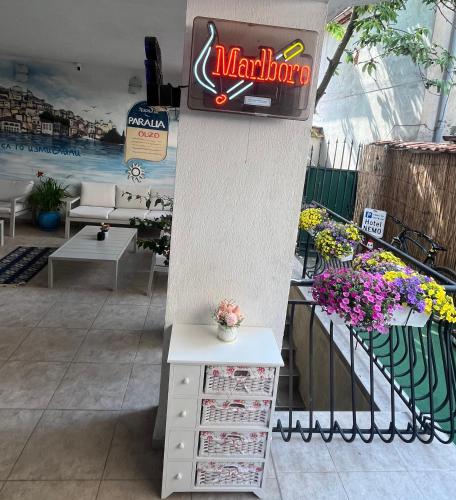 a store with a marauder sign on a column with flowers at Hotel NEMO in Kiten