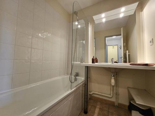a bathroom with a tub and a sink and a shower at Appartement T3 Barbaste in Barbaste