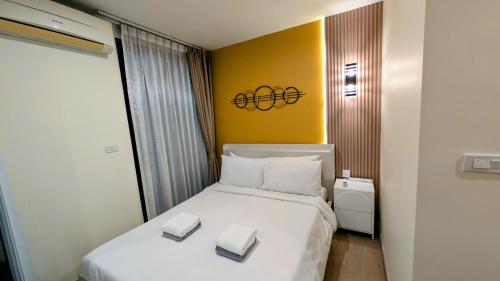 a hotel room with a bed with two boxes on it at Boat Avenue condo in Bang Tao Beach