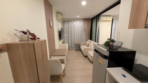 a small living room with a kitchen and a living room at Boat Avenue condo in Bang Tao Beach