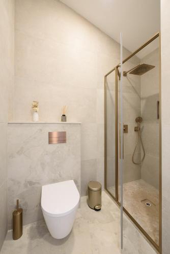 a bathroom with a toilet and a shower at House 61 in Milotski Breg
