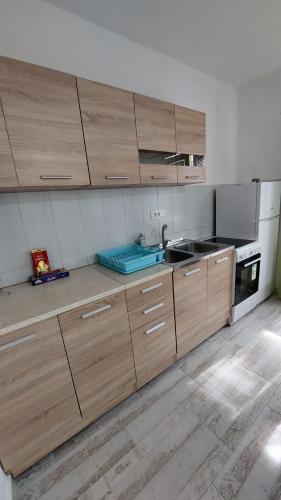 a kitchen with wooden cabinets and a sink at UnaMar 1 in Prčanj