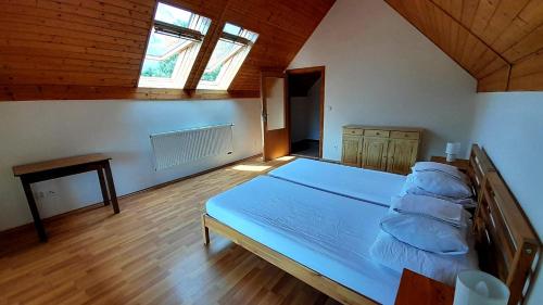 a bedroom with a large bed in a room at Penzion Skřítkův grunt in Struhařov