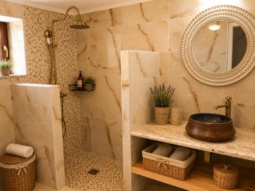 a bathroom with a sink and a mirror at Paliokaliva Home in Roussopoúlion