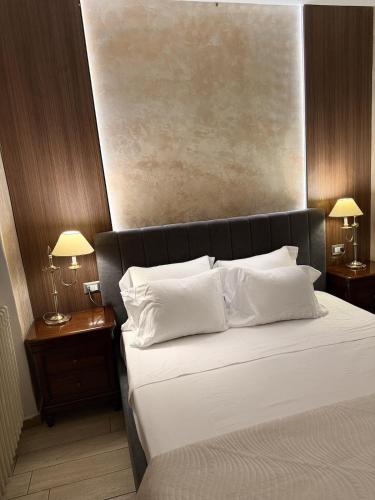 a bedroom with a large bed with white pillows at Siham lake home in Verceia