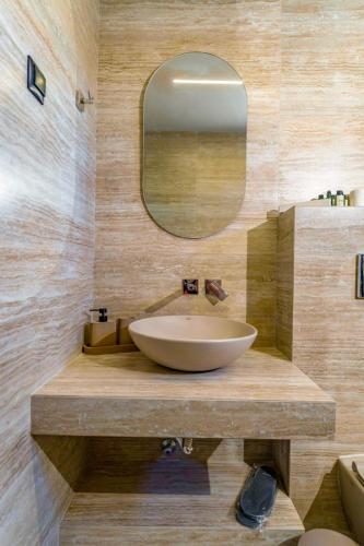 a bathroom with a large sink and a mirror at Filian Apartments in Neos Marmaras