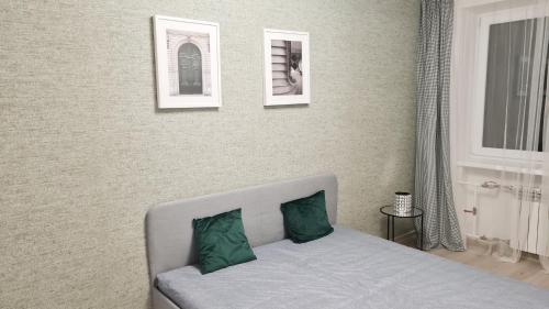 a bedroom with a bed and two pictures on the wall at Boarder City Center Apartment, Võidu tn 5, Apt 16, 4th Floor, Narva in Narva