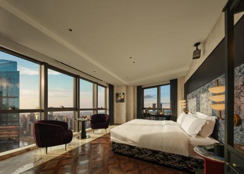 a bedroom with a large bed and large windows at Aranciel 阿岚若 High-Rise River View Hotel -Jiefangbei Area-Hongya Cave in Chongqing