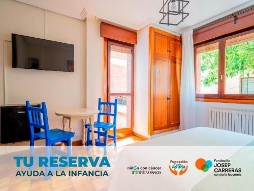 a room with two blue chairs and a table at Oliva Rooms 3000 in Santander