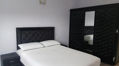 a bedroom with a large bed and a mirror at Mediterraneo House in Tangier
