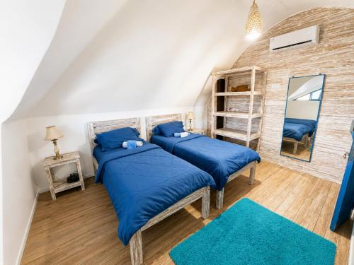 a bedroom with two beds and a mirror at Bali Bio Villas in Uluwatu
