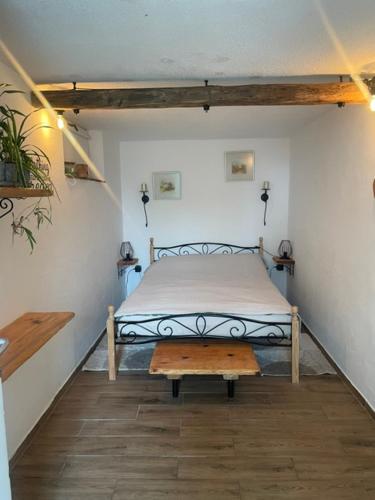 a bedroom with a bed with a bench in it at Sunny Karla apartment Dramlje in Dramlje
