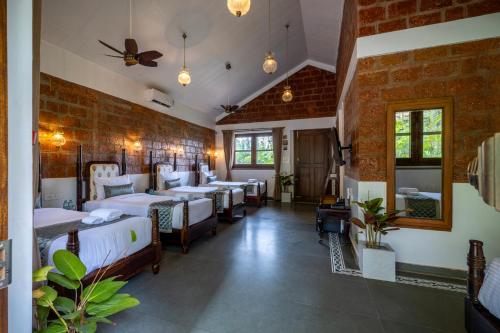a room with a bunch of beds in it at Ashvana Resort in Nidigere