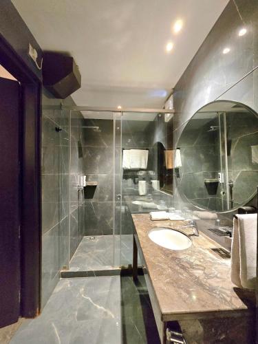 a bathroom with two sinks and a shower at Hotel Royal Castle Grand in New Delhi