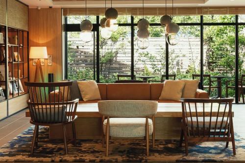 a living room with a couch and two chairs at Fairfield by Marriott Mie Okuise Odai in Odaicho