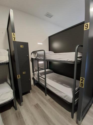 a room with two bunk beds in it at Albergue Adventus in Padrón