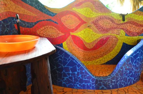 a bathroom with a sink and a mosaic wall at Sublime Eco Hotel - Palomino Tayrona By GHO Hoteles in Palomino