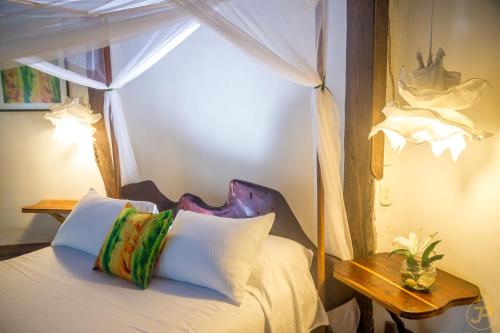 a bedroom with a bed with a canopy at Sublime Eco Hotel - Palomino Tayrona By GHO Hoteles in Palomino