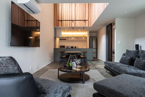 a living room with a couch and a table at The Terrace MAKINO in Takashima