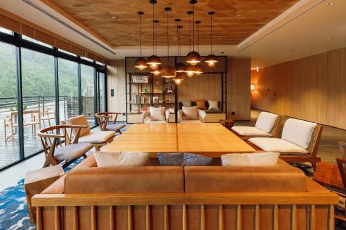 a dining room with a large wooden table and chairs at Fairfield by Marriott Kyoto Kyotamba in Nantan city