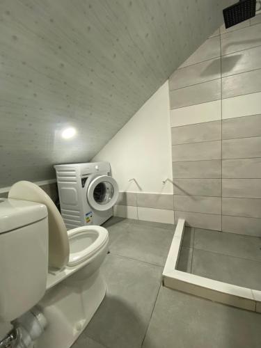a bathroom with a toilet and a shower at Green Home on Mtatsminda in Tbilisi City