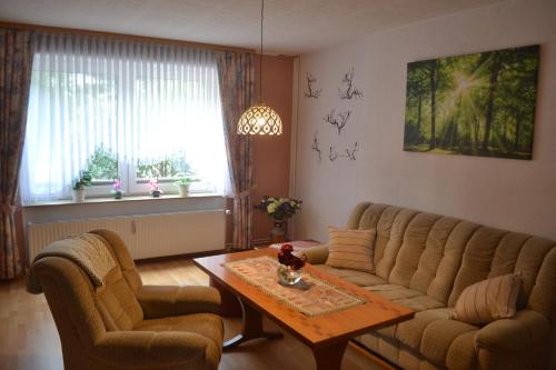 a living room with a couch and a table at Zum Zingelforst in Neudorf