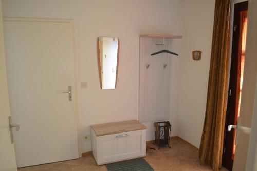 a white room with a door and a mirror at Zum Zingelforst in Neudorf