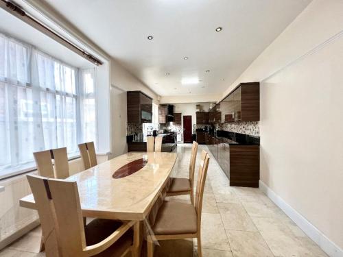 a dining room with a wooden table and chairs at Spacious Double Room In Central Stoke in Stoke on Trent