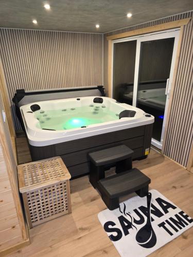 a jacuzzi tub in a room with at Apartamenty Przy Trakcie Cesarskim in Węgierska Górka
