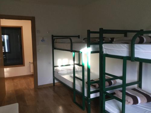 two bunk beds in a room with a hallway at Linar Do Rei in Linares