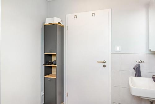 a bathroom with a refrigerator and a sink at Ferienwohnung "Beim Tannenbaum" in Reichensachsen