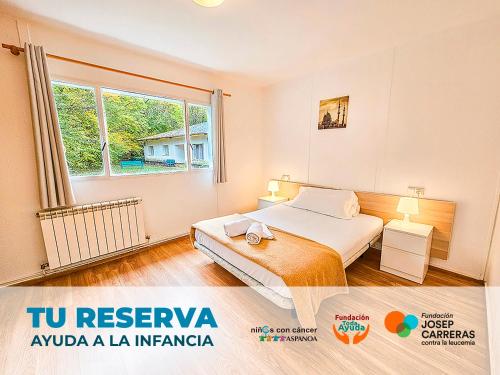 a bedroom with a bed and a large window at Complejo Bubal Formigal 3000 in Búbal