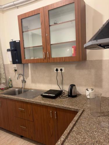 a kitchen counter with a sink and a cabinet at Villa Ecotiva Mahabalipuram in Chennai