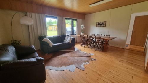 a living room with a couch and a table and chairs at Happy place in Kitee