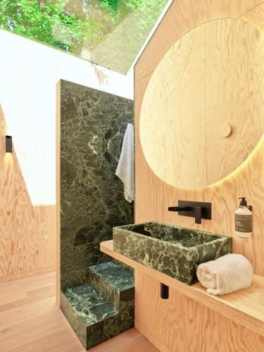 a bathroom with a stone sink and a mirror at Hutstuf La Roche-en-Ardenne in La-Roche-en-Ardenne