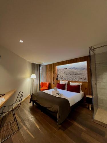 a bedroom with a large bed and a glass shower at Hôtel LAPIAZ & Spa - FLAINE in Flaine