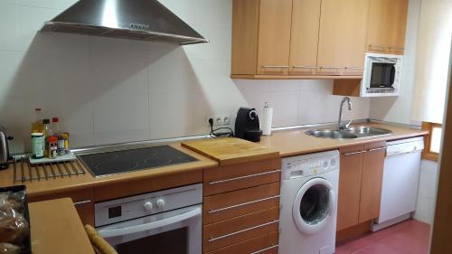a kitchen with a sink and a stove top oven at Apartamentos Alcañiz, Gala in Alcañiz