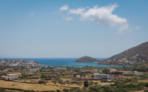 a view of a city and the ocean at Andros Royal Villa in Koumárion