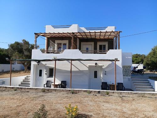a white house with stairs and a porch at Countryside Retreat 1 in Agios Arsenios