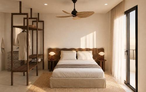 a bedroom with a bed and a ceiling fan at Anoi Kefalonia in Argostoli