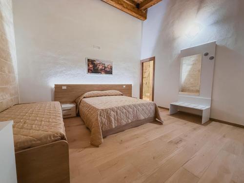 a bedroom with two beds and a couch in it at Agriturismo Tenuta Santarcangelo in Scanzano