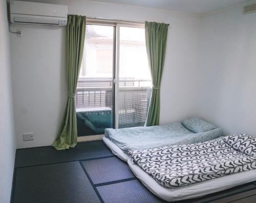 a bedroom with a bed and a window at House Nozomi in Kyoto