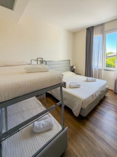 two bunk beds in a room with a window at My Place Hotel in Rimini